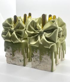 three soap bars with green icing and bows on them