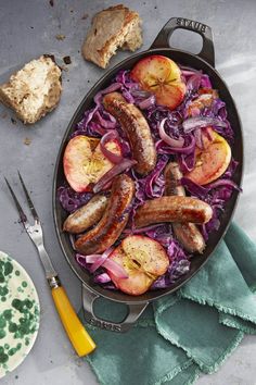 sausages and cabbage in a skillet with bread on the side