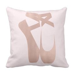 a white pillow with a pair of ballet shoes printed on the front and back of it