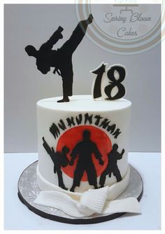 a birthday cake decorated with the silhouettes of two people and one person doing a handstand