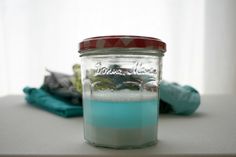 a jar filled with blue liquid sitting on top of a table