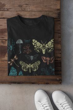 Thanks for stopping by! Moths and Mushrooms T-shirt Printed on a super soft, cotton tee Dispatched in 5 working days or sooner Unisex Free UK delivery Material: 100% ringspun cotton. Chest (to fit): S  34/36   M  38   L  40/42   XL  44/46   XXL  48/50 ECO-FRIENDLY Each garment is made to order, reducing extra material and energy that would be otherwise wasted We use DTG printing process which is easier on the environment than screen-printing Our ink is bright and also eco-friendly. Do not tumble Moths And Mushrooms, Fairycore Clothing, Tshirt Grunge, Clothing Cottagecore, Grunge Tshirt, Indie Clothing, Grunge Clothing, Cottagecore Shirt, Indie Outfits