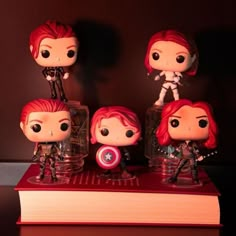 the avengers movie pop vinyl figures are on top of a book