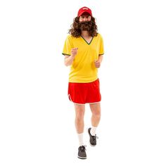 a man with long hair wearing a yellow shirt and red shorts is standing in front of a white background