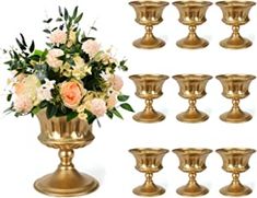 a bunch of gold vases with flowers in them