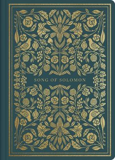 an old book with gold trimmings and floral designs on the cover, in blue