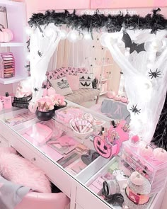 a vanity with pink and black accessories on it in a girls's dressing room