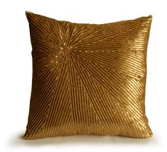 a gold pillow on a white background