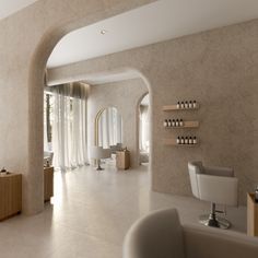 the interior of a hair salon with chairs and shelves on the wall, along with an arched doorway that leads to another room