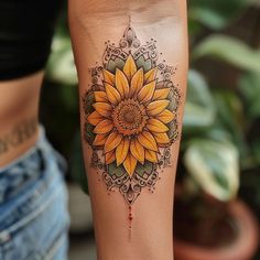 a woman's leg with a sunflower tattoo on it and an ornate design