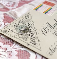 a close up of a wedding card on a lace tablecloth