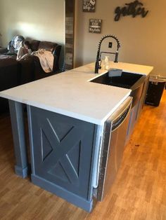 a kitchen island with an open door on the front and side, in a living room