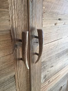 an old wooden door with two metal handles