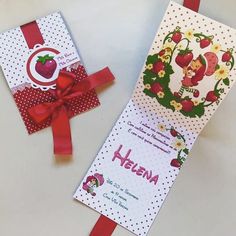 two cards with red ribbon and strawberrys on them