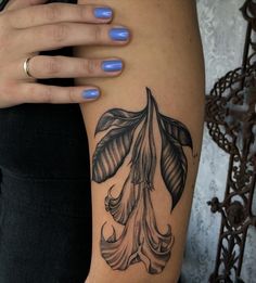 a woman's arm with a tattoo on it and a flower in the middle