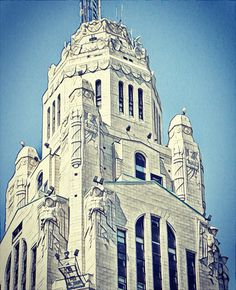 the top of a tall building with a clock on it's side