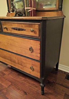 an old dresser with drawers and a mirror on top