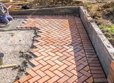 a brick walkway being built in front of a house