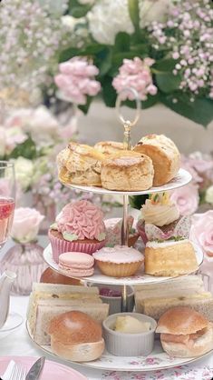 a table topped with three tiered plates filled with pastries