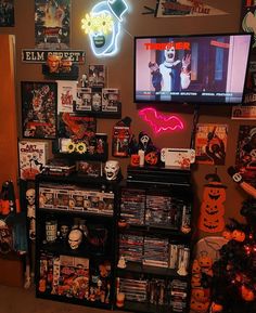 a living room filled with lots of halloween decorations and movies on the wall above it