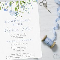 a blue and white floral bridal party card with ribbon, scissors and streamers