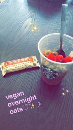 a plastic cup filled with cereal next to a bag of vegan overnight oats