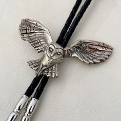 "Listing is for one bolo tie. Original barn owl design was hand carved, then cast in the Heliotrope studio in Tucson, Arizona. Available in brass (gold toned) or white bronze (silver toned). Machine braided, black leather bolo cord. At checkout, please choose the desired cord length: 36\"----- Recommended for people under 6' tall. 42\"----- Recommended for people 6' tall or taller. Wingspan Width 2.75\" Owl Height 1.6\"" Metal Art Jewelry, Gold Animals, Mens Fashion Wedding, Nocturnal Animals, Bolo Tie, Owl Design, Magical Wedding, Barn Owl, Gifts For Wedding Party