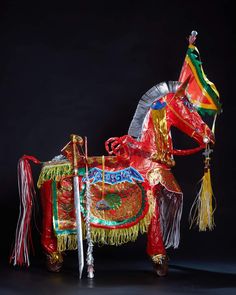 an elaborately decorated horse is displayed on a black background