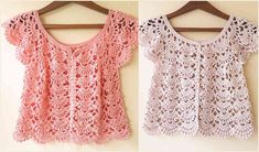 two crocheted tops hanging on a wall next to each other, one in pink and the other in white