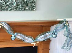 a mantel decorated with seashells and starfish