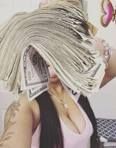 a woman with long hair covering her face and money