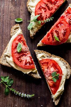 slices of bread with tomatoes and herbs on them