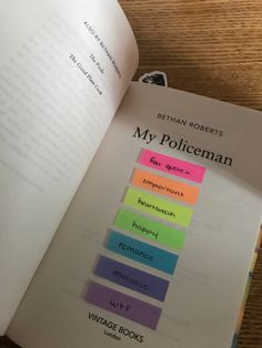 an open book with sticky notes attached to it