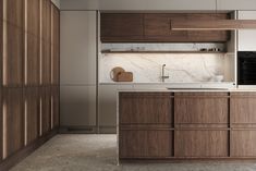 a kitchen with marble counter tops and wooden cabinets