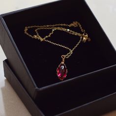 Handmade item Materials: 14k Gold Plated Gemstone: Lab Created Ruby Jewelry type: Necklace Style:  Minimalist Description *Necklace Length : 14inches/16inches/18inches/20inches *Pendant Dimensions : 8mm X 17mm *Chain Thickness : 1.3mm 🌻Tips on Caring for Jewelry: - If you want your jewelry to look new at all times please take jewelry off before showering. - Please keep it away from chemicals, water, and high temperature, it can be too harsh for your stone. - Store it well. A ring box or airtight ziplock bag is the perfect place to keep them. Do not hesitate to contact me with any doubts, I will be happy to help you!  : ) CHECK MORE JEWELRY https://www.etsy.com/shop/CaitlinsJewelryHouse?ref=seller-platform-mcnav Thank you for visiting my shop! Raw Ruby Necklace, Dainty Crystal Clavicle Chain Necklace For Gift, Dainty Clavicle Chain Crystal Necklace For Gift, Jeweled Teardrop Necklace As Gift, Teardrop Jeweled Necklace Gift, Dainty Pendant Crystal Necklace For Her, Dainty Crystal Pendant Necklace As Gift For Her, Dainty Ruby Gemstone Necklace, Gift Jeweled Teardrop Pendant Necklace