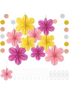 pink and yellow paper flowers hanging from strings