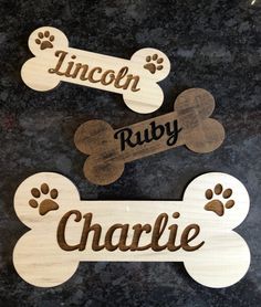 three wooden dog bone magnets with the words lincoln ruby and charlie written on them