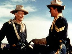 two men in cowboy hats standing next to each other