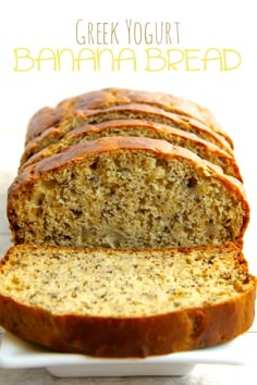 a loaf of greek yogurt banana bread on a white plate with text overlay