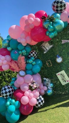 a bunch of balloons that are in the grass