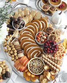 a platter filled with lots of different types of snacks and desserts on plates