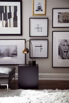 a living room with pictures on the wall