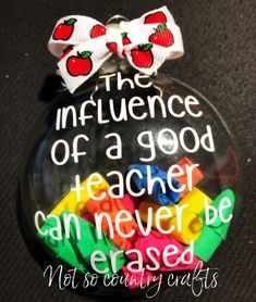 a glass ornament with words on it that says the influence of a good teacher can never be erase