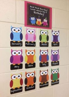 a bulletin board with owls on it in a school hallway for kids to write their name