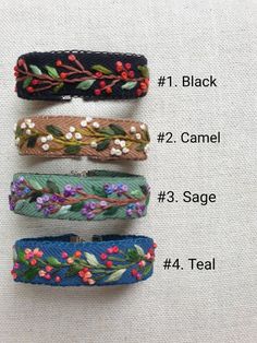 four different types of hair clips with flowers and leaves on them, all labeled in the following words