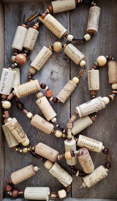 a box filled with lots of wine corks on top of a wooden floor covered in beads