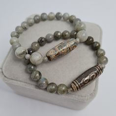 Agate DZI bracelet. Tibetan talisman. Labradorite beads stretch bracelet. Tibetan talisman for a gift. Bracelet size made to order. Please send me the size of your wrist so the bracelet will fit perfectly. Beads size: Dzi - 2.9×1 cm/1.17×0.42 inches. Labradorite - 4, 6, and 8 mm/0.17, 0.22 and 0.32 inches. If you choose to pack No.2, leave me a message about which stamp you would like (Crown, Cloverleaf, Just Smile). I will choose the color of the stamp at my discretion if you do not have any ot Spiritual Beaded Bracelets With Natural Stones For Good Luck, Dzi Bracelet, Spiritual Polished Bead Stretch Bracelet As Gift, Spiritual Polished Beads Stretch Bracelet, Spiritual Stretch Bracelet With Polished Beads As Gift, Hand-strung Agate Stretch Bracelet For Meditation, Adjustable Labradorite Spiritual Beaded Bracelets, Adjustable Labradorite Beaded Bracelets For Spiritual Wear, Adjustable Labradorite Beaded Bracelets For Spiritual Healing