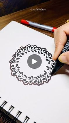 a person is drawing on paper with a marker