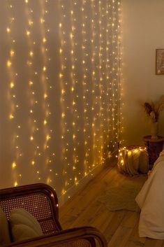 The combination of lights, decorations, and the wooden furniture creates an inviting atmosphere filled with warmth and holiday cheer. Fairy Light Curtain, Strip Curtains, Outdoor Led Strips, Led Curtain Lights, Ambience Lighting, 70s Aesthetic, Christmas Room Decor, Twinkling Lights, Cozy Room Decor