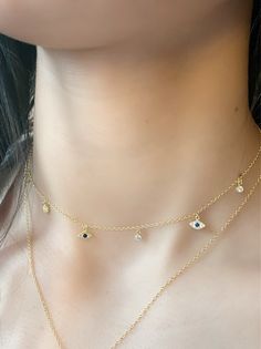 Evil Eye Charm Choker, dainty Evil Eye CZ Charm Choker Necklace is designed to provide strength and protection from negative energy. Layer this choker with anyone of our necklaces or wear it alone, either way you are guaranteed good vibes. * Round Brilliant Cubic Zirconia Stones * 18k Yellow Gold Plated or Rhodium Plated Sterling Silver * Chain Length: Adjustable from 12 inches to 15 inches * Spring Clasp Closure. Evil Eye Charm Necklace, Dainty Evil Eye Necklace, Neck Pieces Jewelry, Necklace Evil Eye, Choker Necklace Designs, Turkish Eye, Charm Choker Necklace, Pretty Jewelry Necklaces, Choker Gold